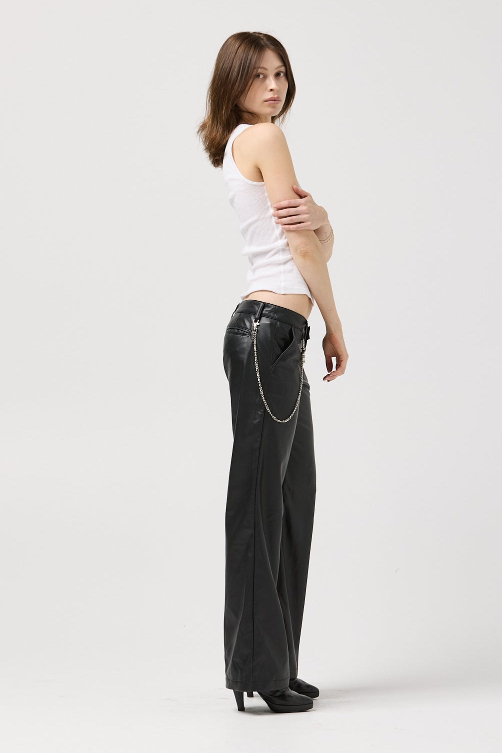 Extended tab hook and bar closure on vegan leather trouser